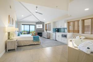 a large bedroom with a bed and a bath tub at Seascape Beach Resort in Aptos