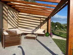 a patio with two lounge chairs and a wooden pergola at Casa Ripa Guest House in Cupramontana +2 photos