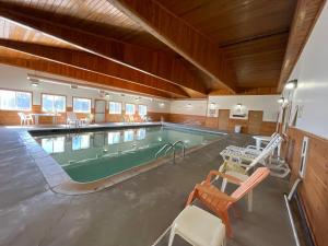 a large swimming pool in a large building at Ausable Valley Inn in Mio
