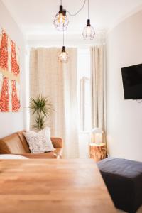 a living room with a couch and a tv at Cozy and stylish studio in Kamppi in Helsinki