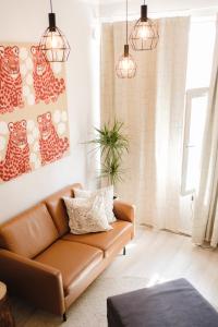 a living room with a brown leather couch at Cozy and stylish studio in Kamppi in Helsinki