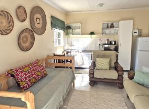 a living room with a couch and a chair at KatiKati Eco Lodge in White River