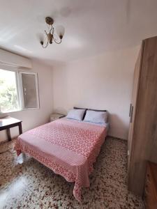 a bedroom with a bed with a pink blanket at Сozy House in Alicante +2 photos