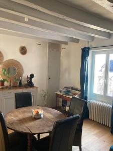 a dining room with a table and chairs and a window at Azay le rideau centre ville in Azay-le-Rideau