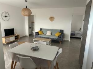 a living room with a table and a couch at Les jardins de Saint Pancrace in Corte