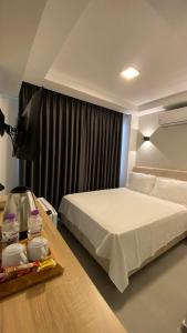 a bedroom with a bed and a table with a television at The Brothers Suite Dalaman in Dalaman