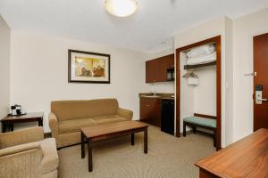 a living room with a couch and a table at Holiday Inn Express & Suites Whitecourt by IHG in Whitecourt