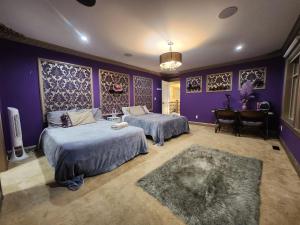 薩里的住宿－The Empress Palace Hotel，一间卧室设有两张床和紫色墙壁
