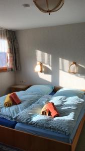 a bedroom with a bed with two animals laying on it at Haus Imgard in Lenzkirch