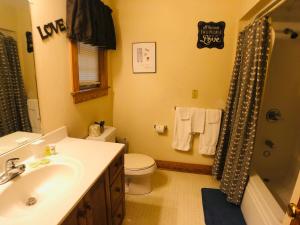 a bathroom with a sink and a toilet and a shower at Briarstone Lodge Condo 13B by Eden Crest in Pigeon Forge