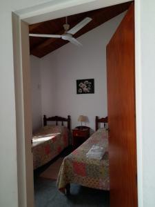 a room with two beds and a ceiling fan at El Zohar 4 pax in Federación