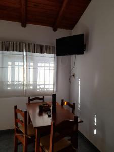 a dining room with a table and a television on the wall at El Zohar 4 pax in Federación