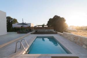 a swimming pool in the middle of a house at Kedros Katikies in Kalamaki