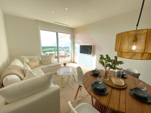 a living room with a white couch and a table at Limonero16 in Orihuela Costa