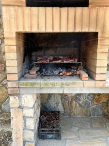a brick oven with meat and other food in it at Villetta Zuccale II Tranquillità e panorama vicino al mare in Capoliveri