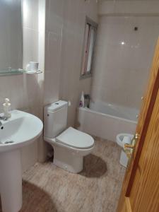Un baño con inodoro, lavabo y bañera. en Vivienda Turística Argollones 2022, en Almería