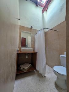 a bathroom with a sink and a toilet at Casa Mi María in Campeche