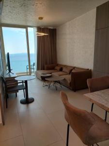 a living room with a couch and a table at Palase Four C apartment 243-E GC in Palasë