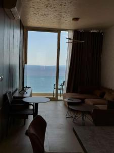 a living room with a view of the ocean at Palase Four C apartment 243-E GC in Palasë
