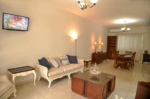 a living room with a couch and a table at FINCA LUZ DEL MAR in Topolobampo