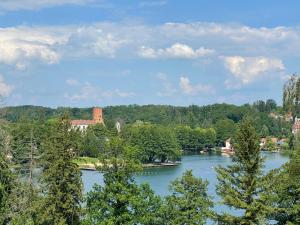 a view of a river with trees and buildings at WILLA BOHEMA in Łagów