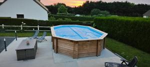 a large hot tub sitting on top of a patio at Chambre à louer in Bonnétable
