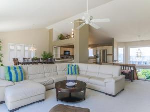 a living room with a white couch and a table at As Good As It Gets in Surf City