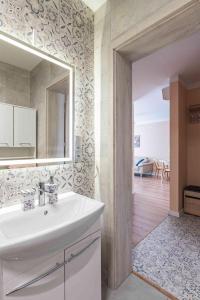 a bathroom with a sink and a mirror at Nowy apartament - Bulwary nad Sołą - 52m2 in Oświęcim