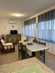 a living room with a wooden table and chairs at Sardegna Pittulongu in Olbia