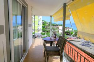 a balcony with a table and chairs and the ocean at Bella Vista in Borsh