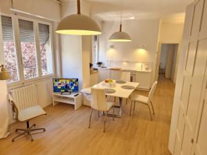 a kitchen and dining room with a table and chairs at La Casa Bianca di Jo in La Spezia