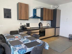 a kitchen with a table and chairs in a room at Palase Four C apartment 190-A GC in Palasë
