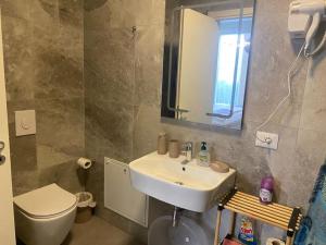 a bathroom with a sink and a toilet and a mirror at Palase Four C apartment 190-A GC in Palasë +20 photos