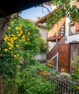 Un jardín con flores amarillas y una puerta de madera. en Torlacite, en Chiprovtsi 27 fotos más