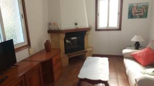 a living room with a couch and a fireplace at Casa cheve in Cangas de Morrazo