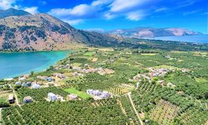 an aerial view of a village on a hill next to a lake at Cretan Breeze Villa Heated Pool in Dhrámia