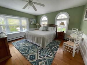 a bedroom with a bed and a table and chairs at Bourne Bed and Breakfast in Ogunquit