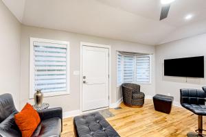 a living room with a couch and a flat screen tv at Blossoming Beauty in Decatur