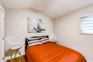 a bedroom with an orange bed and a window at Blossoming Beauty in Decatur