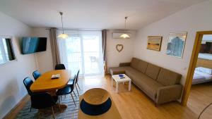 a living room with a couch and a table at Apartman Bebic in Klek