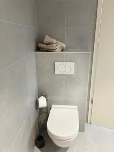 a bathroom with a white toilet and a towel at Central apartment in Luxembourg City Center -Parking in Luxembourg