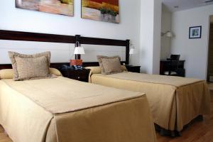 Cama ou camas em um quarto em Villaggio Hotel Boutique