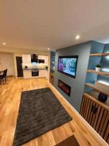 a living room with a flat screen tv on a wall at Minster Bells Suite in York