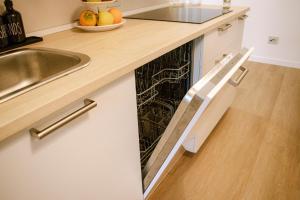 a dishwasher in a kitchen with a sink at B&B Gianchia in Brentino Belluno +13 photos
