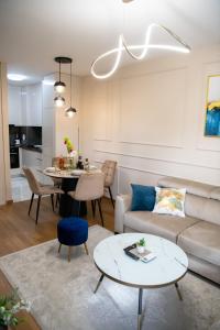 a living room with a couch and a table at Harmony Space Apartment in Banja Luka