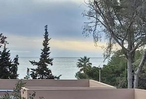 a view of the ocean from a house at Chambre d'hôtes exceptionnelle B&B in Saint-Raphaël