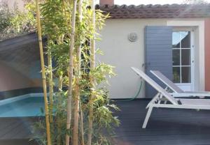 a deck with a chair and a swimming pool at Chambre d'hôtes exceptionnelle B&B in Saint-Raphaël