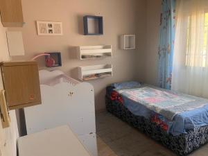a small room with a bed in a room at Acomodação Nunes in Matola +9 photos
