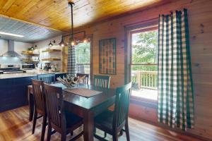 a kitchen and dining room with a table and chairs at Hawk Hollow in Ellijay
