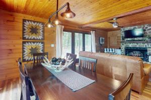a dining room with a table and a couch at Hawk Hollow in Ellijay